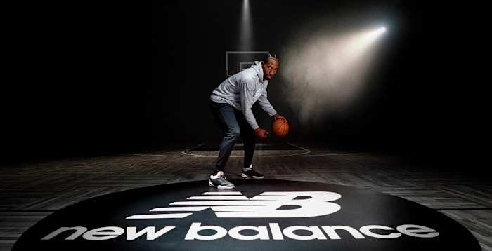 Kawhi Leonard dribbles basketball in photo shoot.